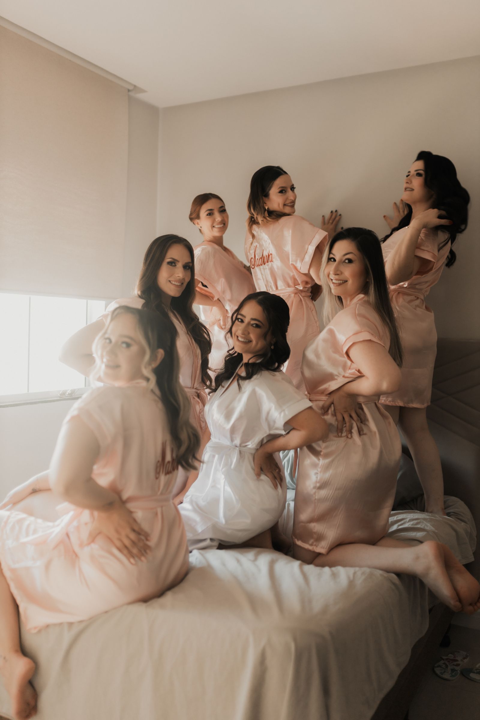 Bridesmaids laughing together while getting ready