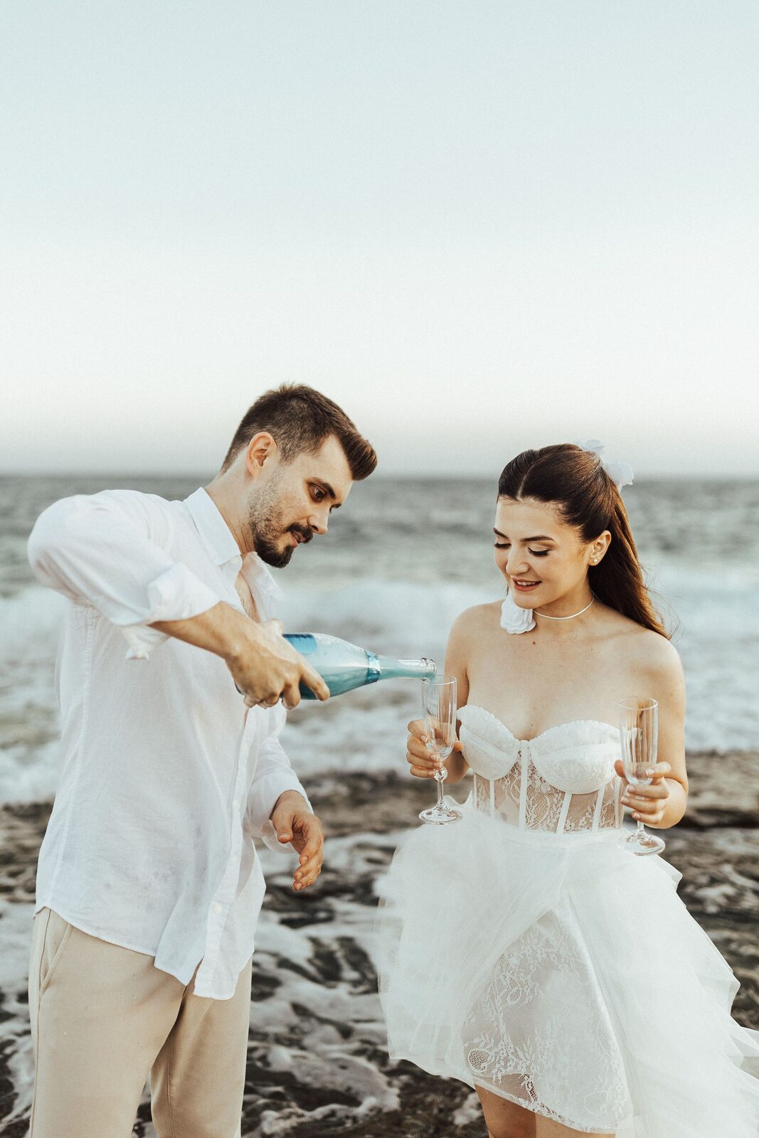 Sofia and Cameron laughing together on the coast