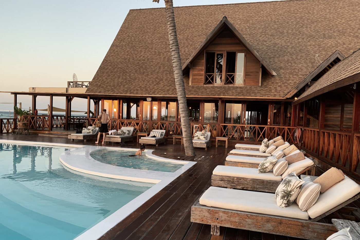 Quiet tropical hotel pool surrounded by palms