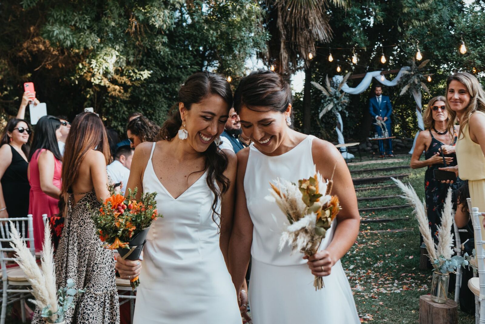 Lena and Rose walking together after their garden ceremony