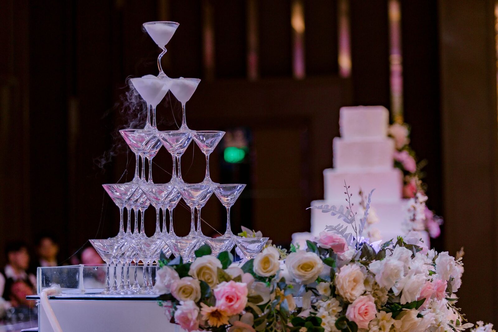 Champagne tower with colorful flowers at a garden wedding