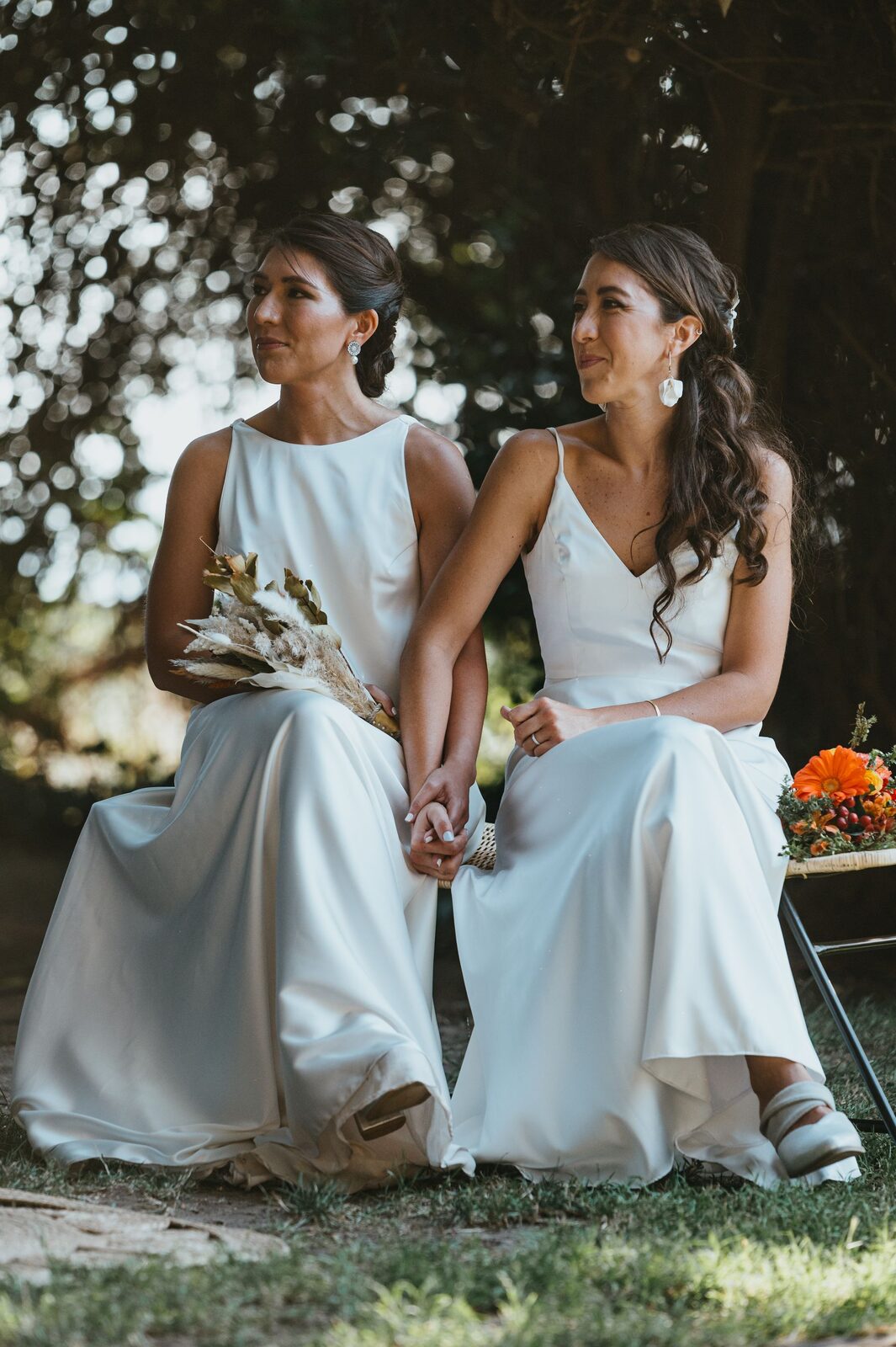 Lena and Rose sitting together beneath the trees
